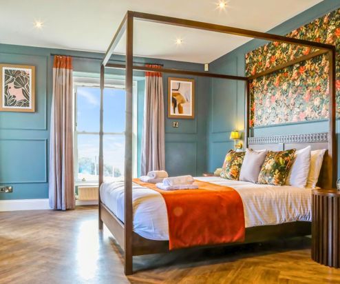 Internal of a manor house master bedroom with four poster bed 