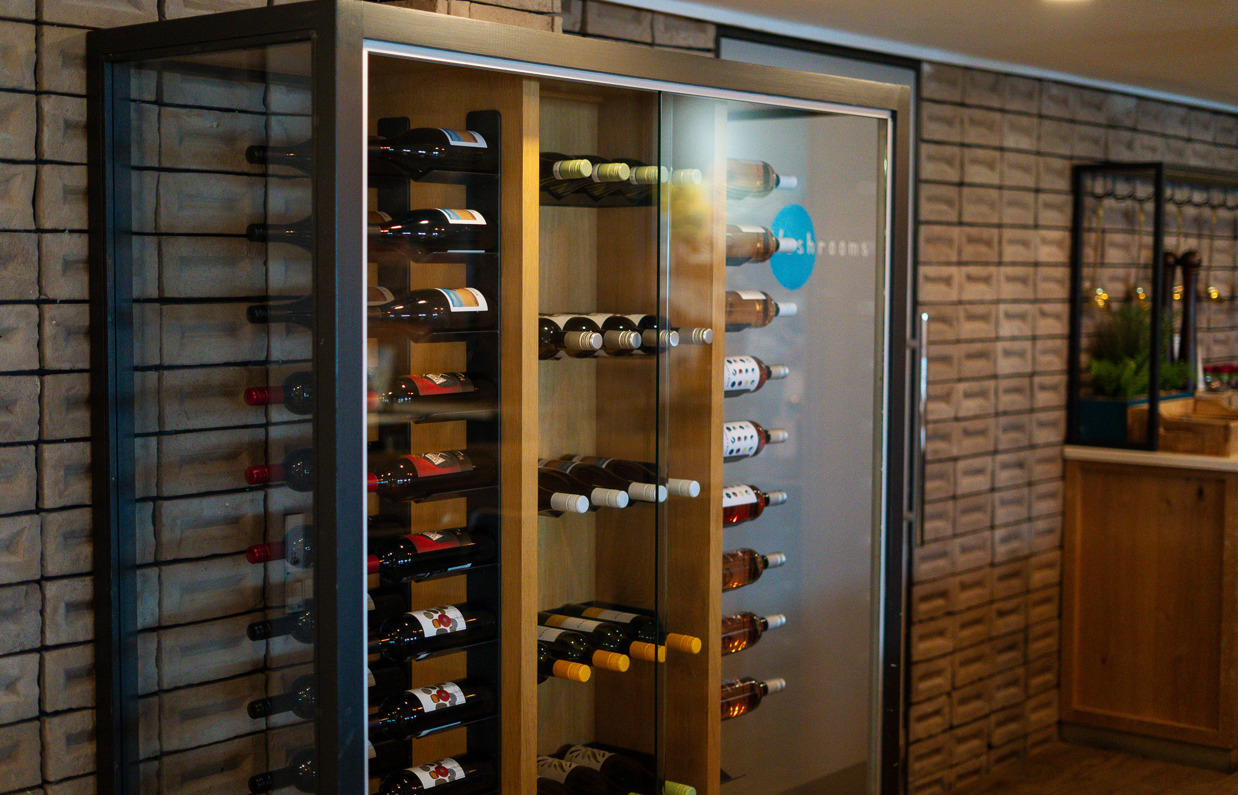 A large wine rack filled with wine bottles in Breeze Bar & Grill