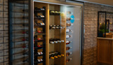 A large wine rack filled with wine bottles in Breeze Bar & Grill