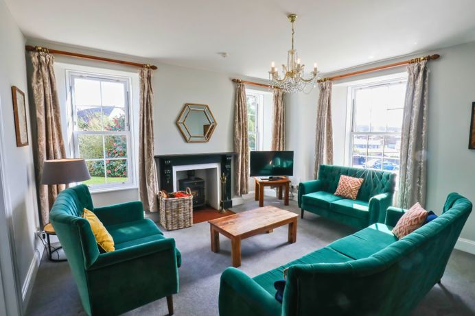 Internal of a manor house lounge with sofas and a tv