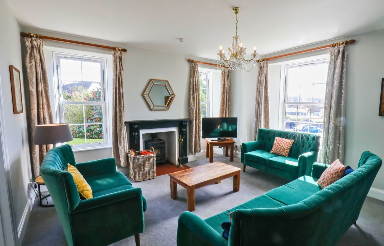 Internal of a manor house lounge with sofas and a tv