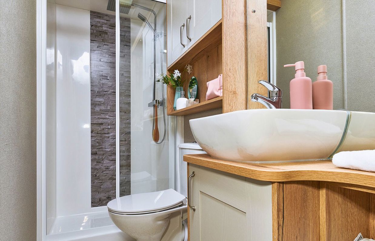 Internal of a caravan bathroom with shower, sink and toilet