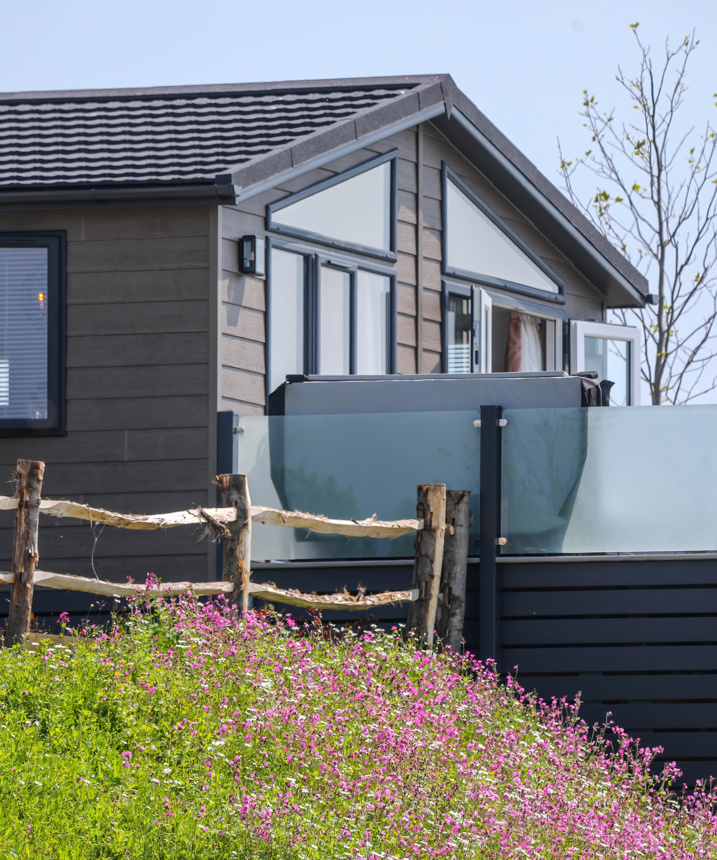 A luxury lodge with decking on Samphire Cove at Tregoad Holiday Park