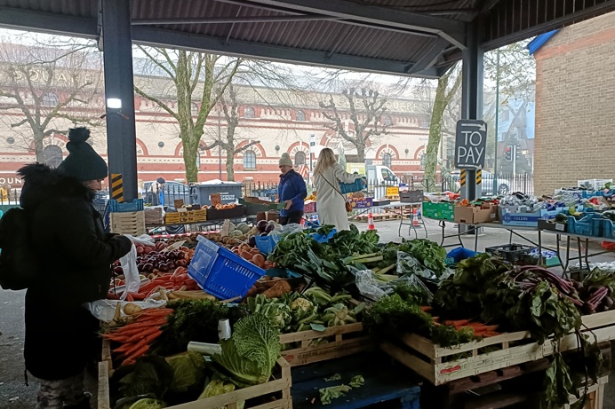 A market stall under cover with fresh produce