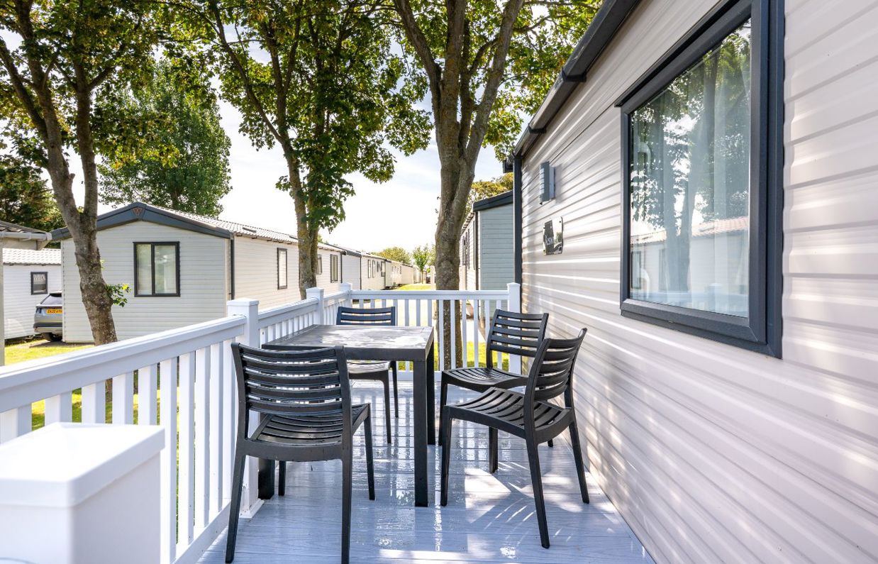 External of a caravan with decking and outdoor furniture