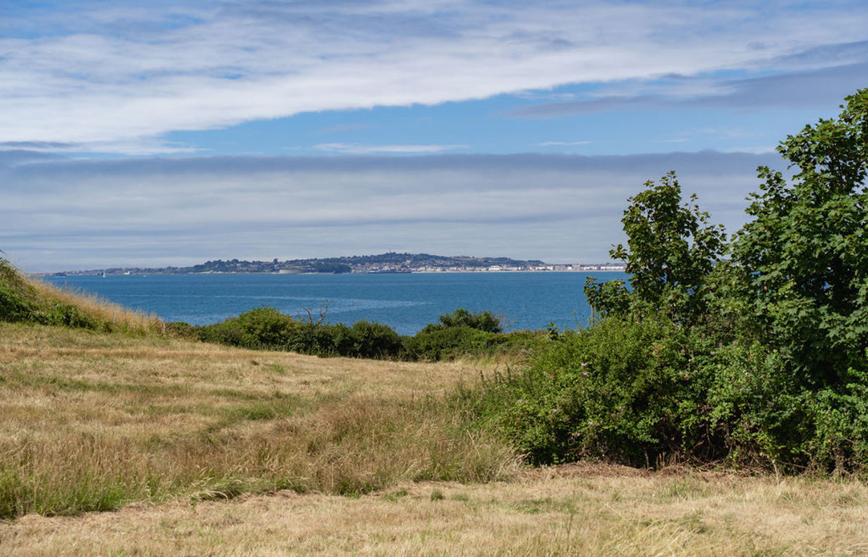 View out to Portland across field from Osmington Mills Lodge Park