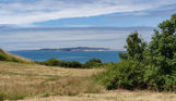 View out to Portland across field from Osmington Mills Lodge Park