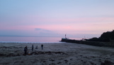 The view of Banjo Pier from Looe Beach at sunset with pink skies