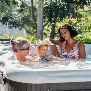 Family relaxing in hot tub on their decking together