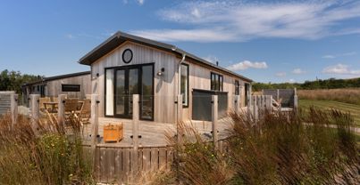 External of a cabin with decking and outdoor furniture