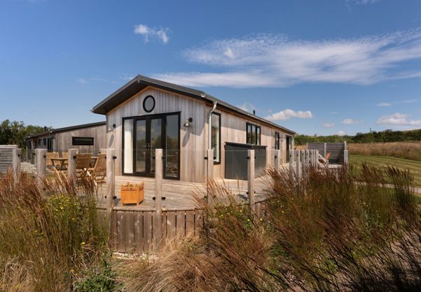 External of a cabin with decking and outdoor furniture