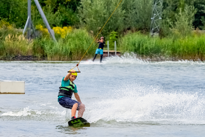 A young man water skiing in a lake