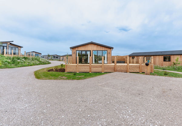External of a luxury lodge on pitch with decking