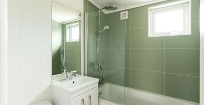 Internal of a luxury lodge bathroom with shower over bath toilet and sink