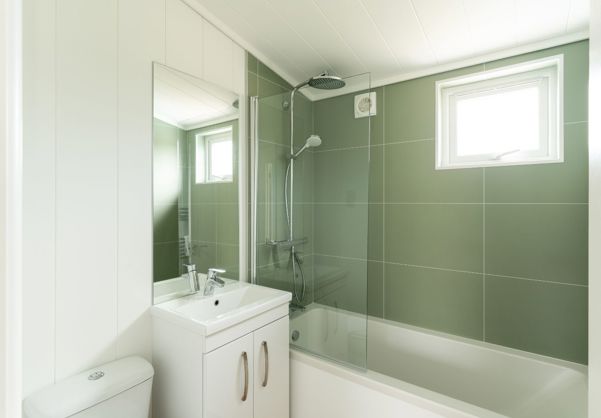 Internal of a luxury lodge bathroom with shower over bath toilet and sink