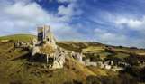 The ruins of a castle perched atop a hill among the Purbeck Hills