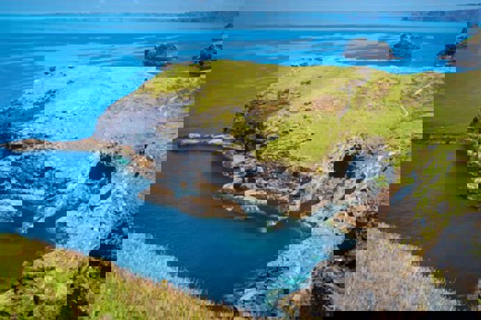 A section of rocky coastline and blue sea