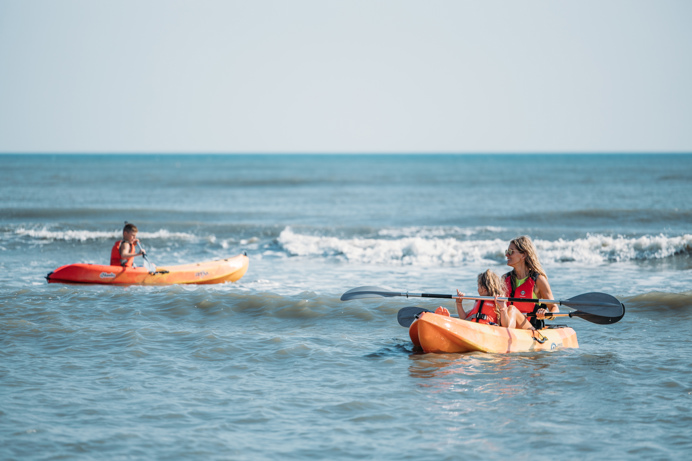 Family kayak on beach together