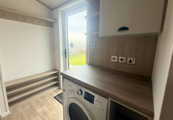 Internal of a caravan entranceway with washing machine and storage
