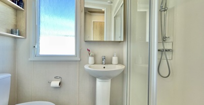 Internal of a caravan bathroom with shower, sink and toilet