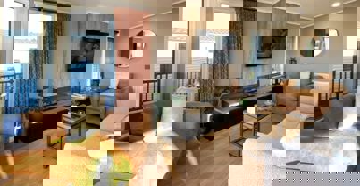 Lounge with large modern fireplace and cosy sofa and armchairs