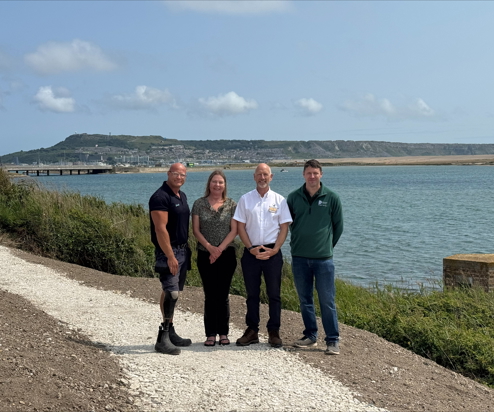 Image of 4 people stood on the restored South West Coast Path at Chesil Beach Holiday Park by the Jurassic Coast