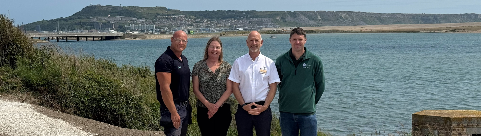 Image of 4 people stood on the restored South West Coast Path at Chesil Beach Holiday Park by the Jurassic Coast