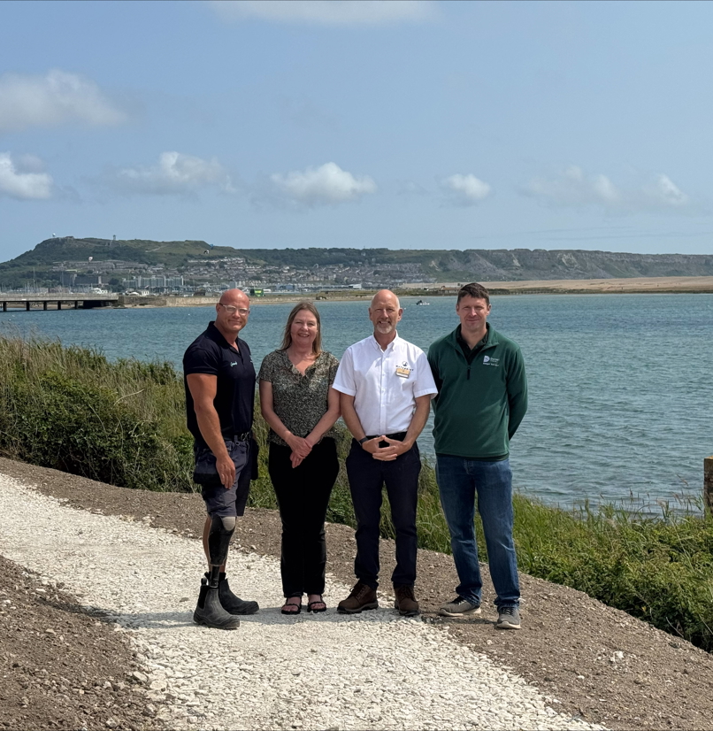 Image of 4 people stood on the restored South West Coast Path at Chesil Beach Holiday Park by the Jurassic Coast