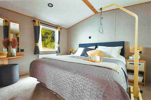 Internal of a classic accessible unit with a double bed and a hoist 