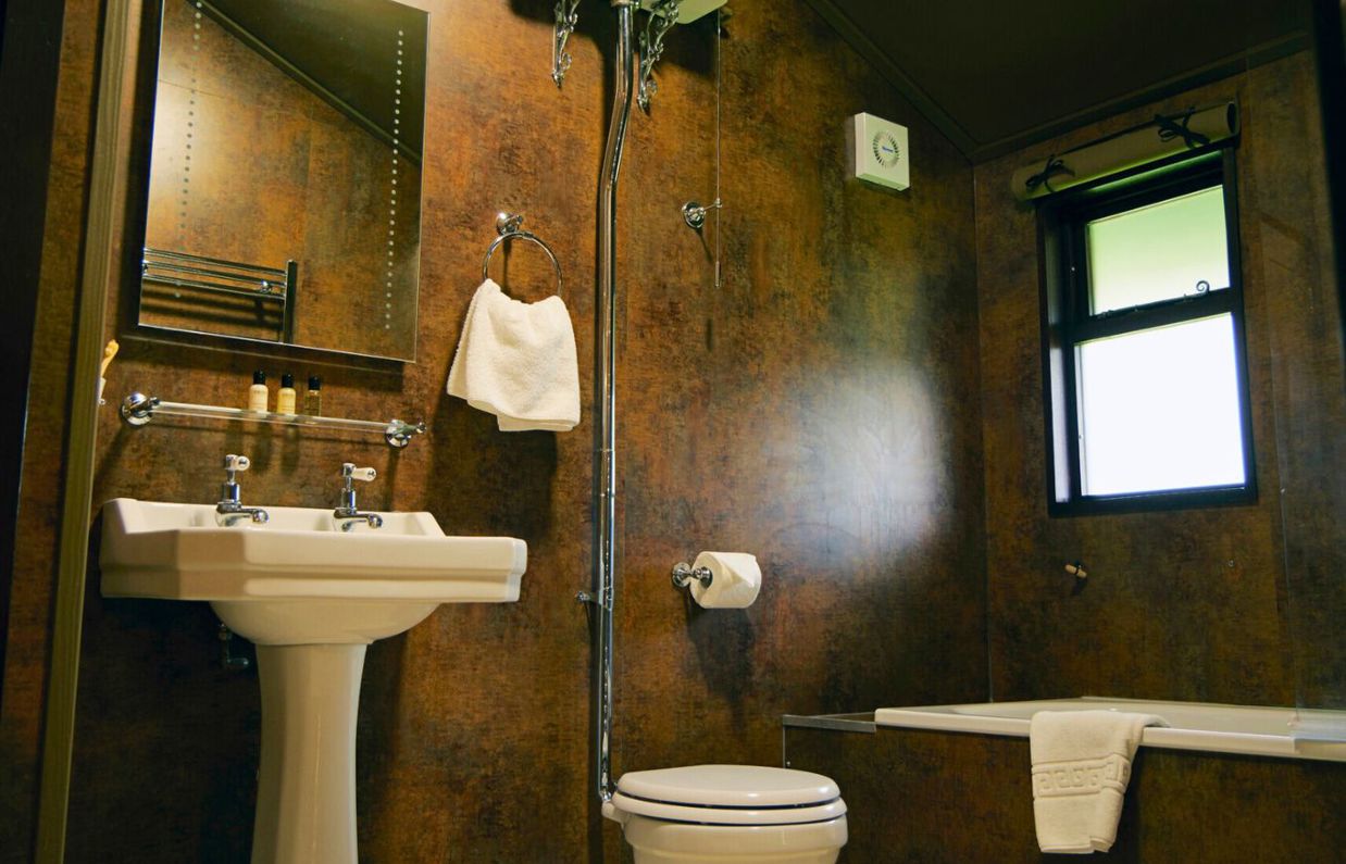 Internal of safari tent bathroom with bath, sink and toilet