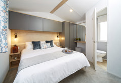 Internal of a caravan double bedroom with ensuite and dressing area