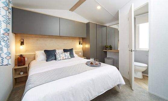 Internal of a caravan double bedroom with ensuite and dressing area