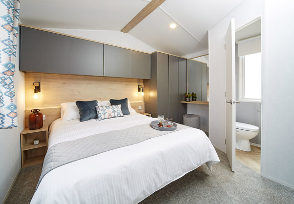 Internal of a caravan double bedroom with ensuite and dressing area