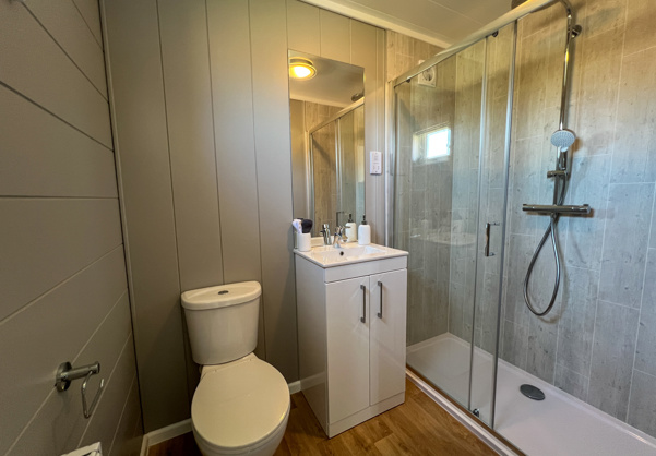 Internal of a luxury lodge ensuite bathroom with shower, sink and toilet