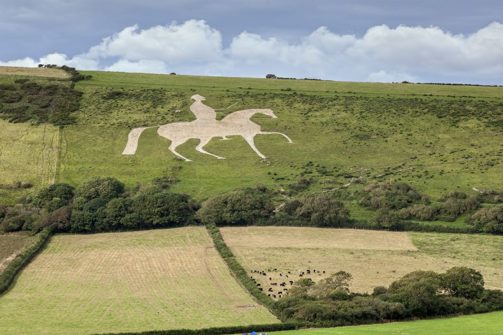 A white horse with King George riding it made out of stone carved out on the hillside
