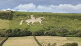 A white horse with King George riding it made out of stone carved out on the hillside