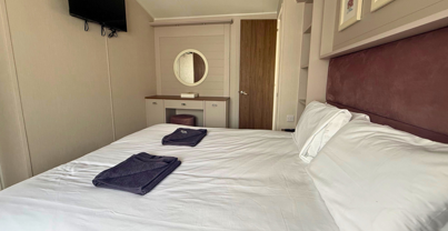 Internal of a caravan master bedroom with dressing area