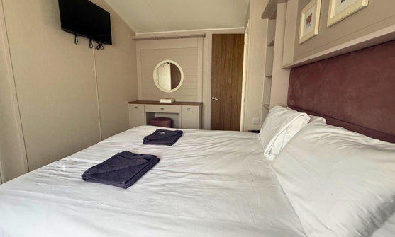 Internal of a caravan master bedroom with dressing area