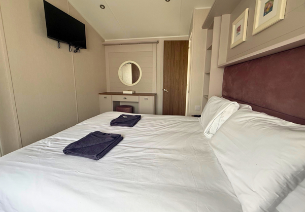 Internal of a caravan master bedroom with dressing area