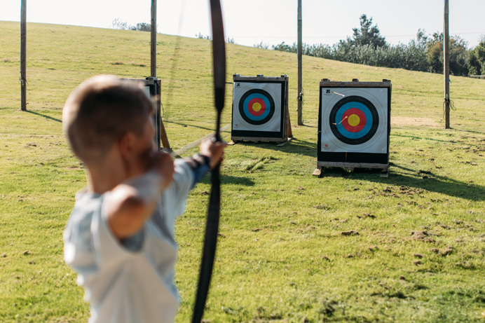 A Young Boy Playing Archery in the Countryside