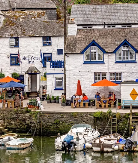 A quaint cottage-style pub alongside the harbour with boats docked