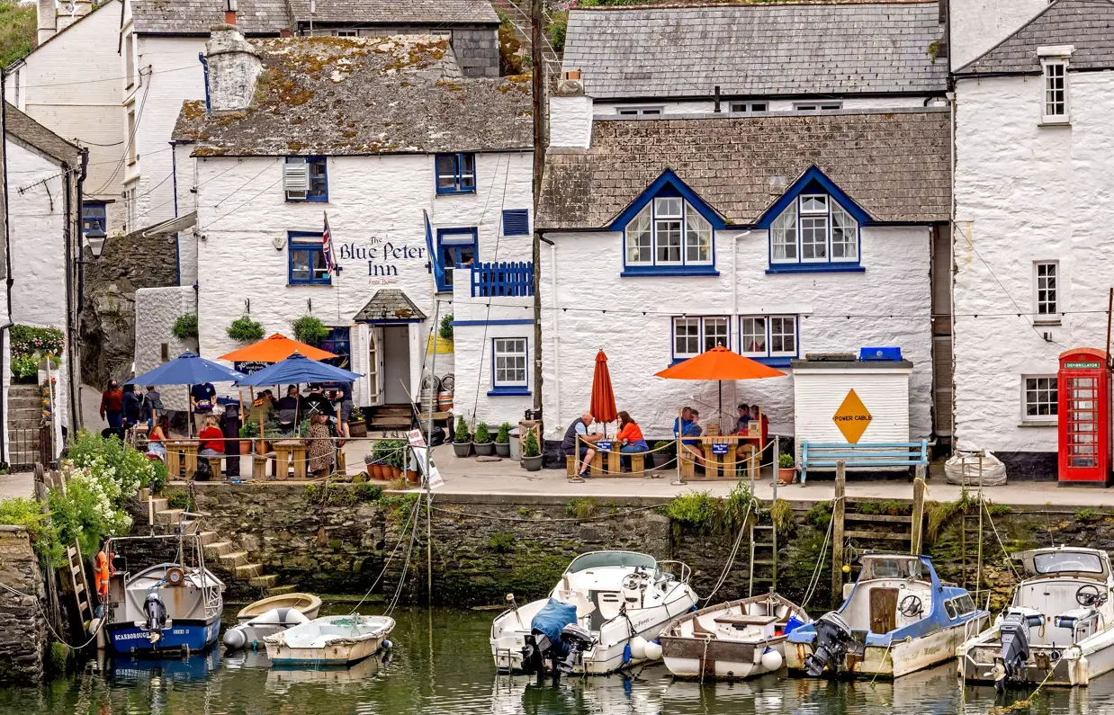A quaint cottage-style pub alongside the harbour with boats docked