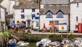 A quaint cottage-style pub alongside the harbour with boats docked