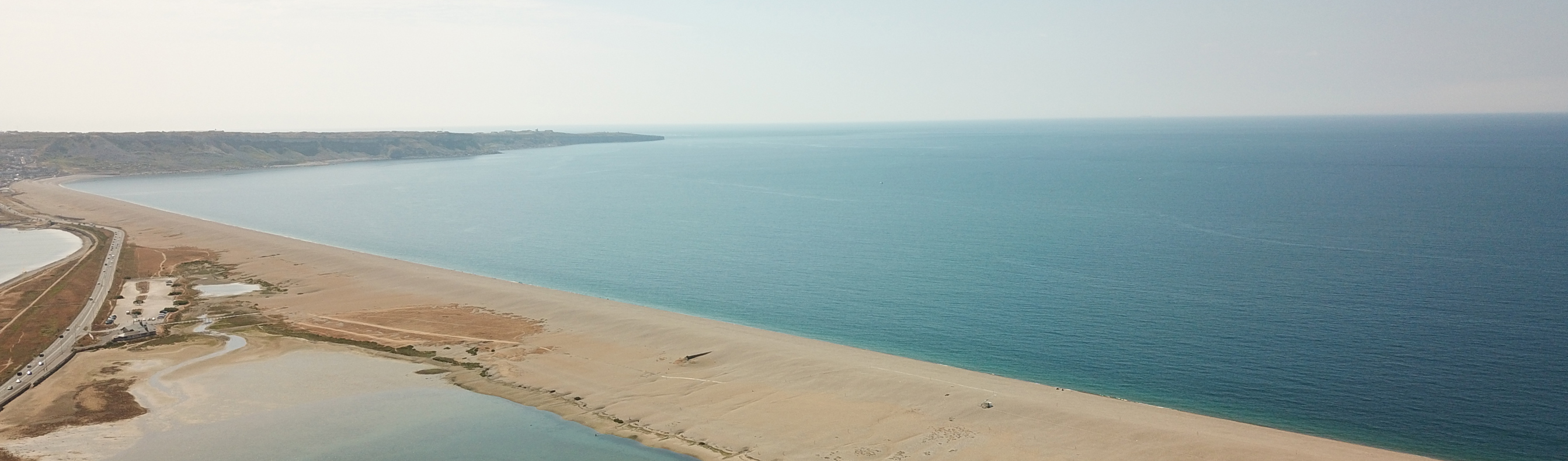 Birds eye view of Chesil Beach and Lagoon next to Chesil Beach Holiday Park