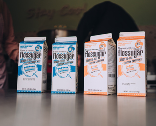 Four cartons of candy floss sugar in retro style packaging