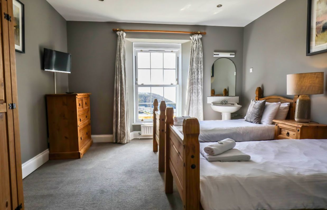 Internal of a manor house twin bedroom with sink 