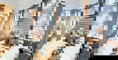 Master bedroom with coastal theme and sliding doors opening into en suite