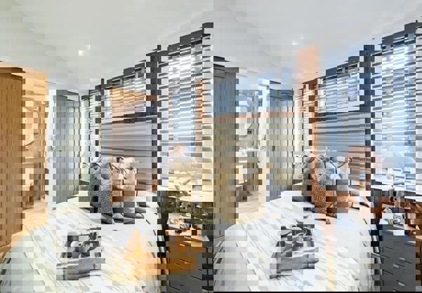 Master bedroom with coastal theme and sliding doors opening into en suite