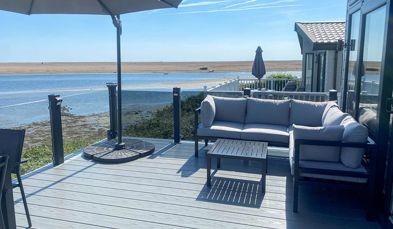 External of a caravan decking with outdoor furniture and seaviews