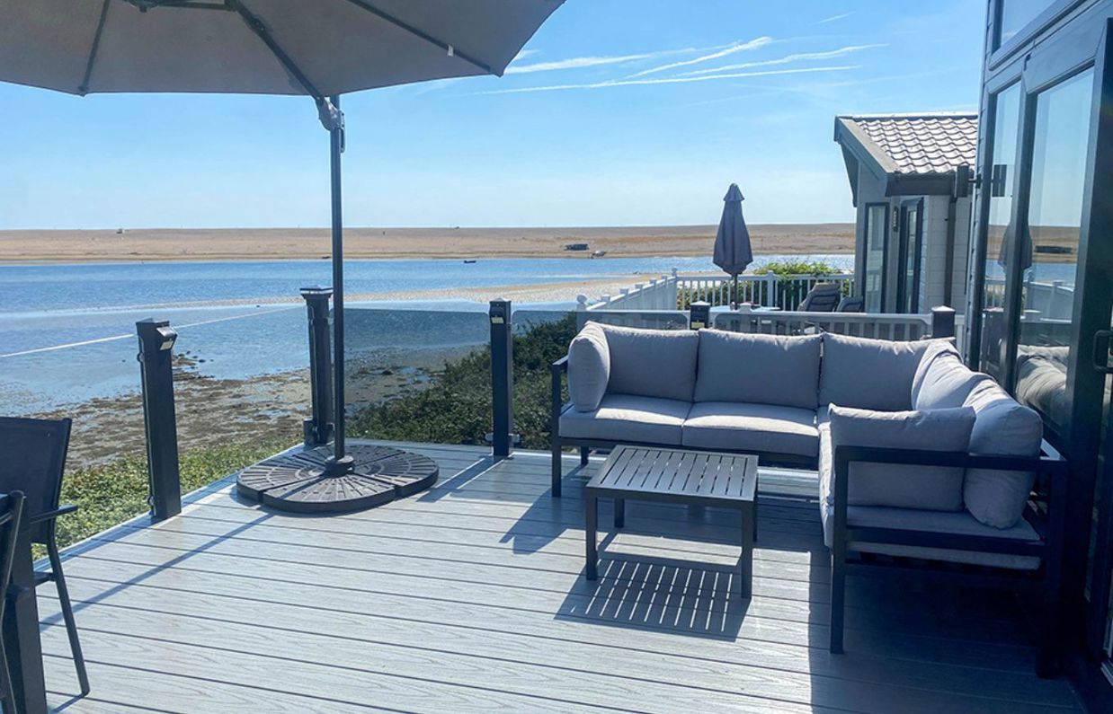 External of a caravan decking with outdoor furniture and seaviews